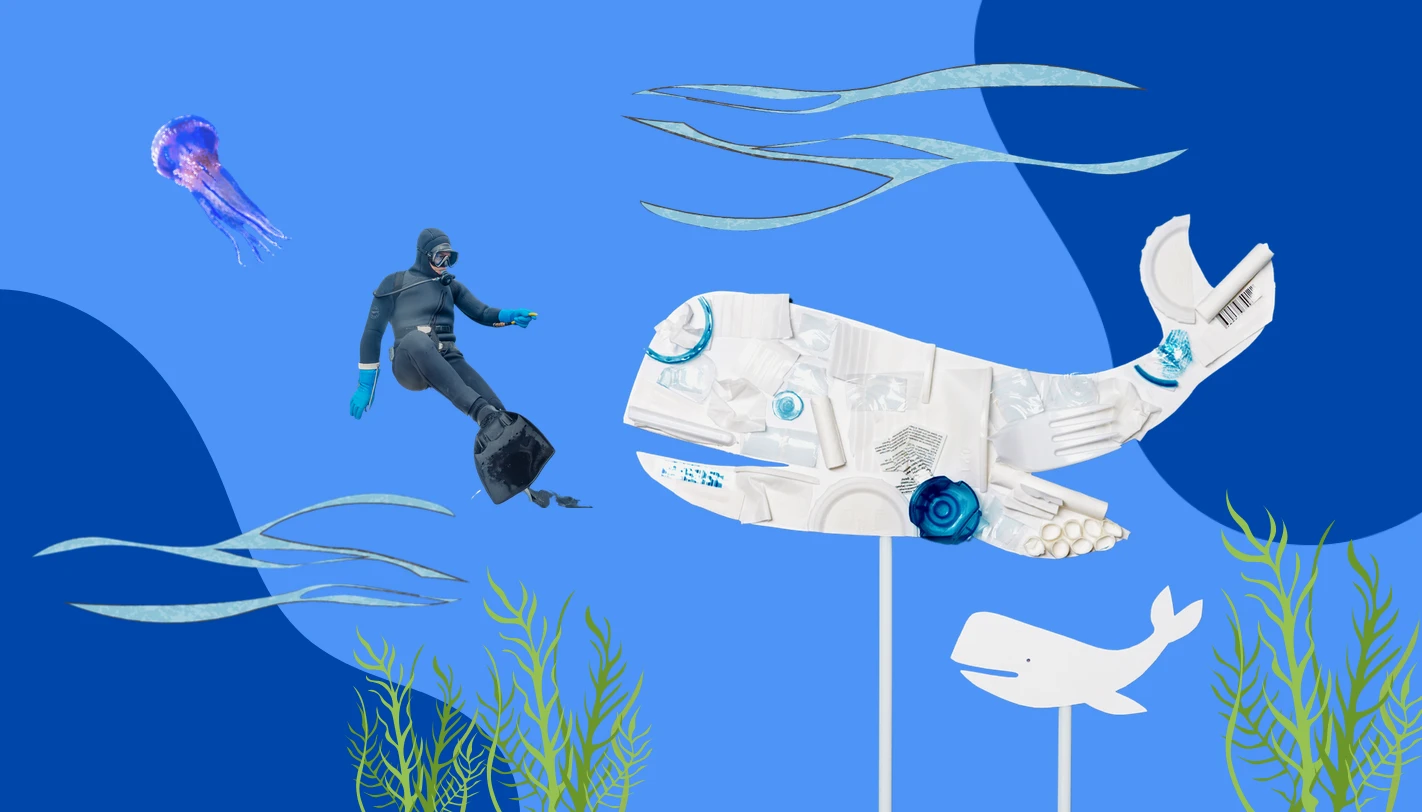 Diver swimming toward a whale sculpture made from recycled plastic
